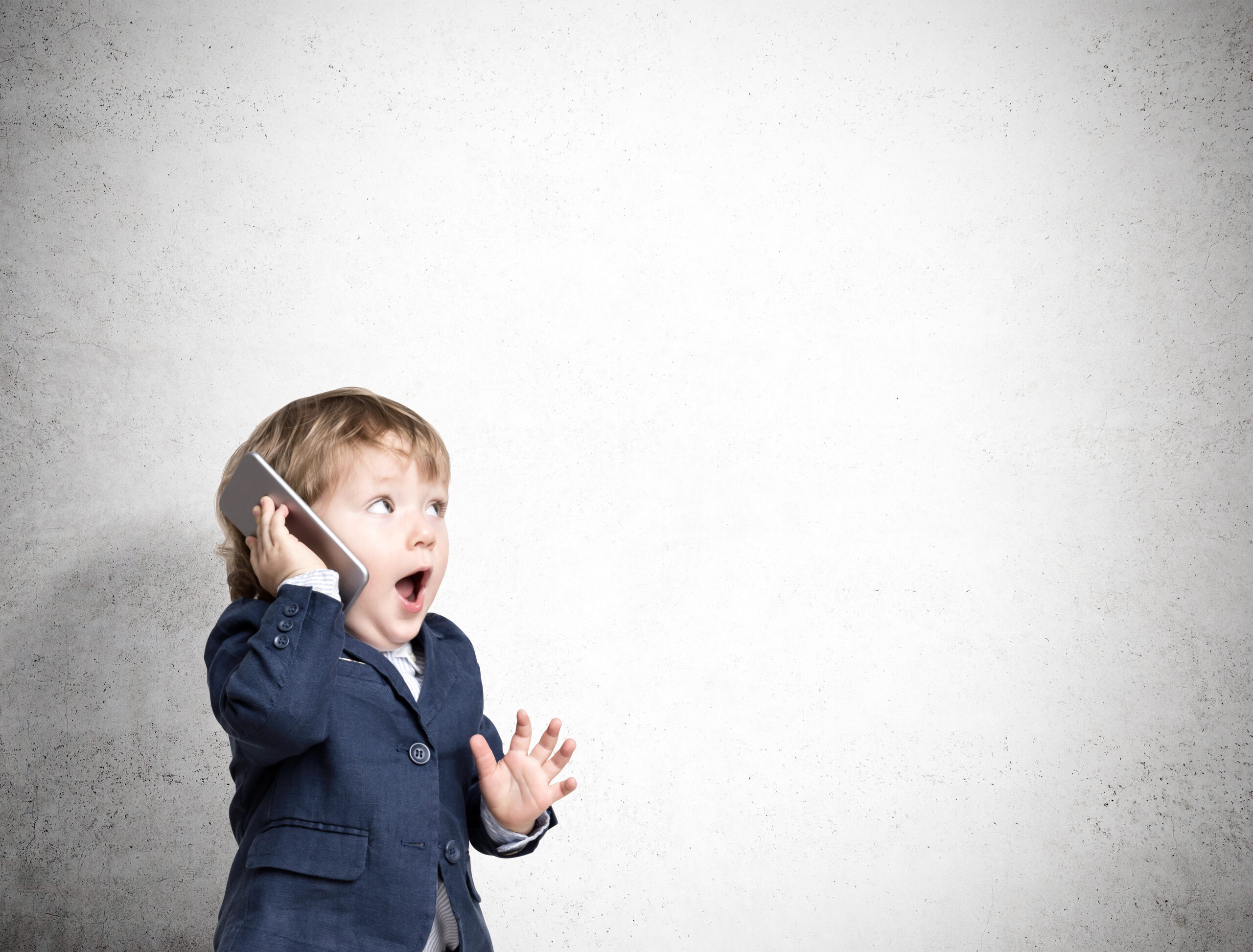 Cute little child is talking on his smartphone