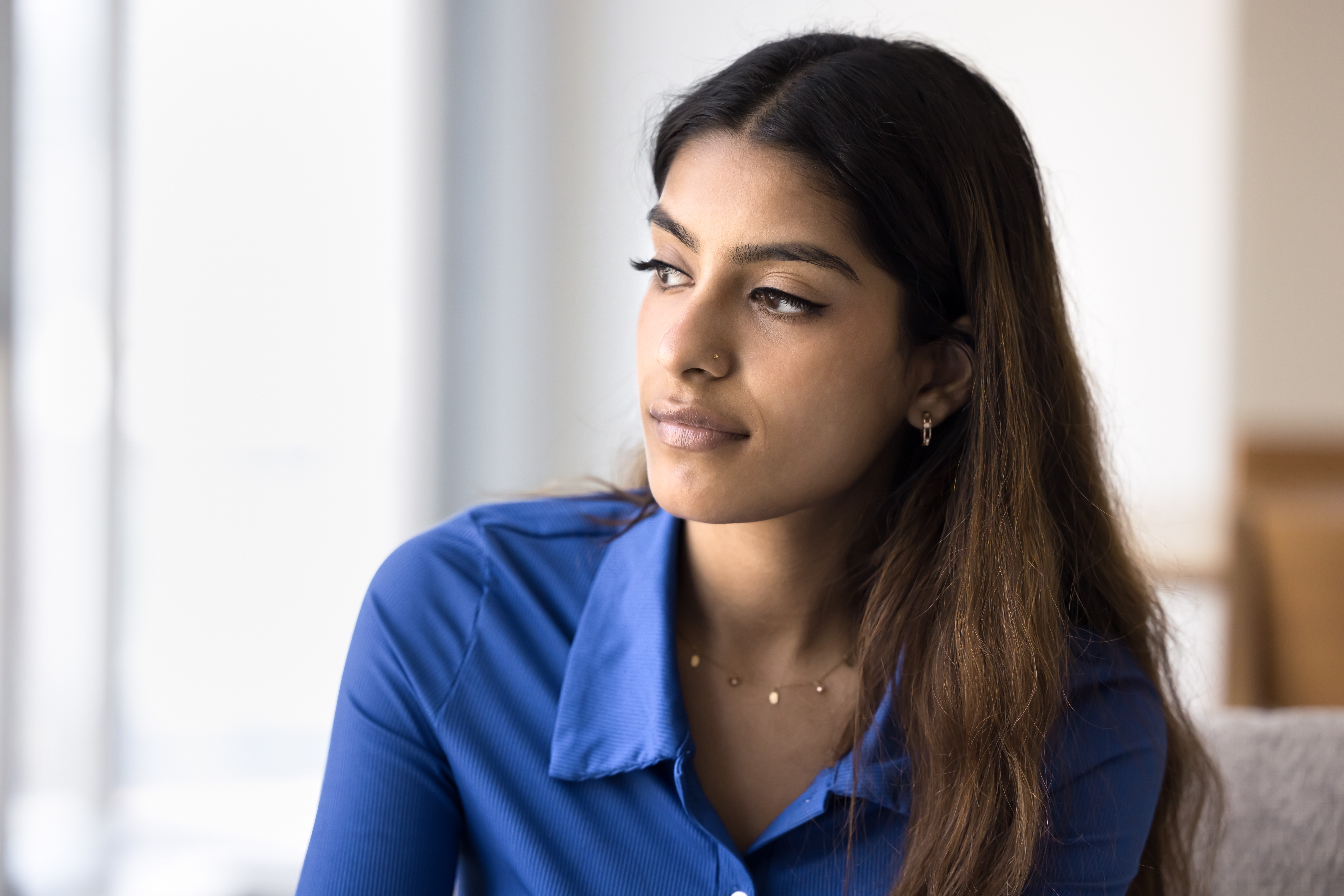 Serious pensive beautiful Indian woman looking away