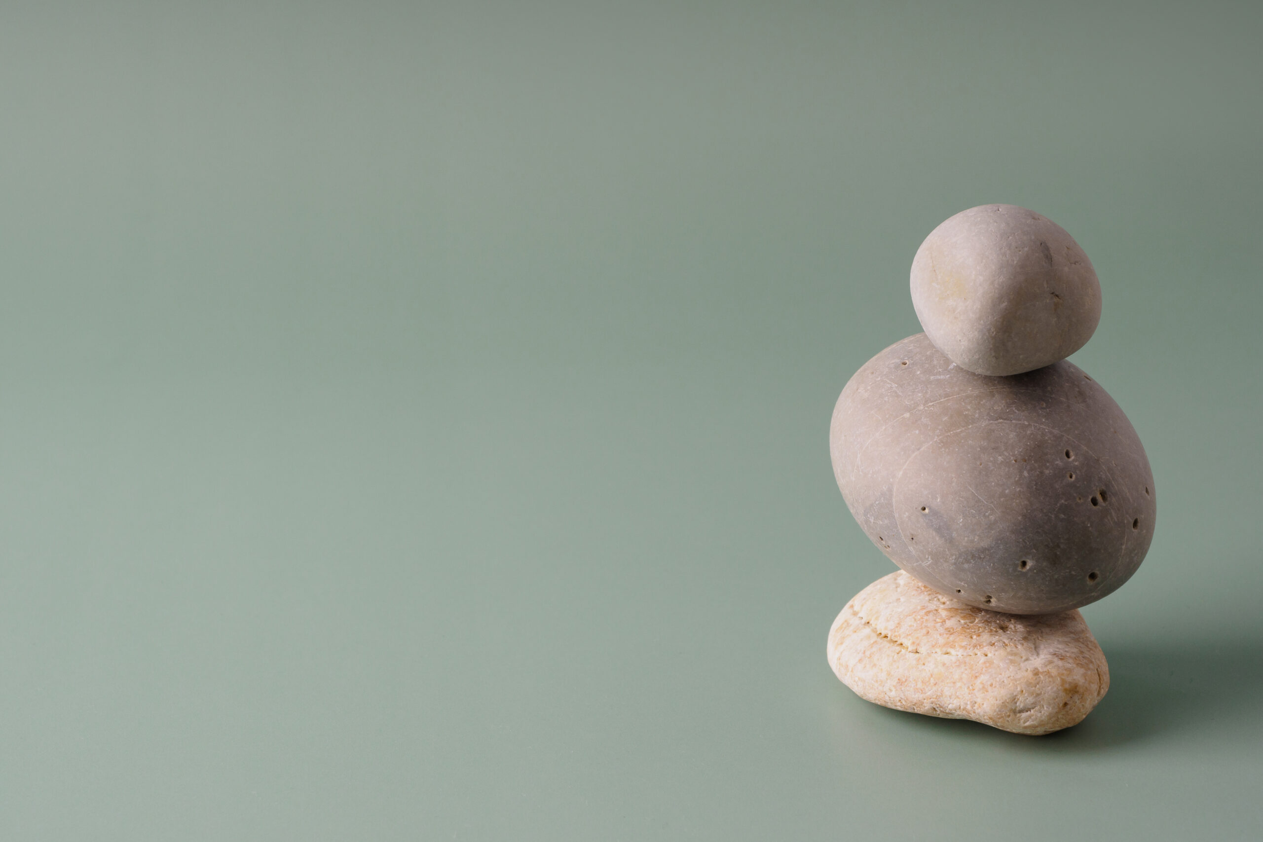 A stack of sea stones on a pastel background