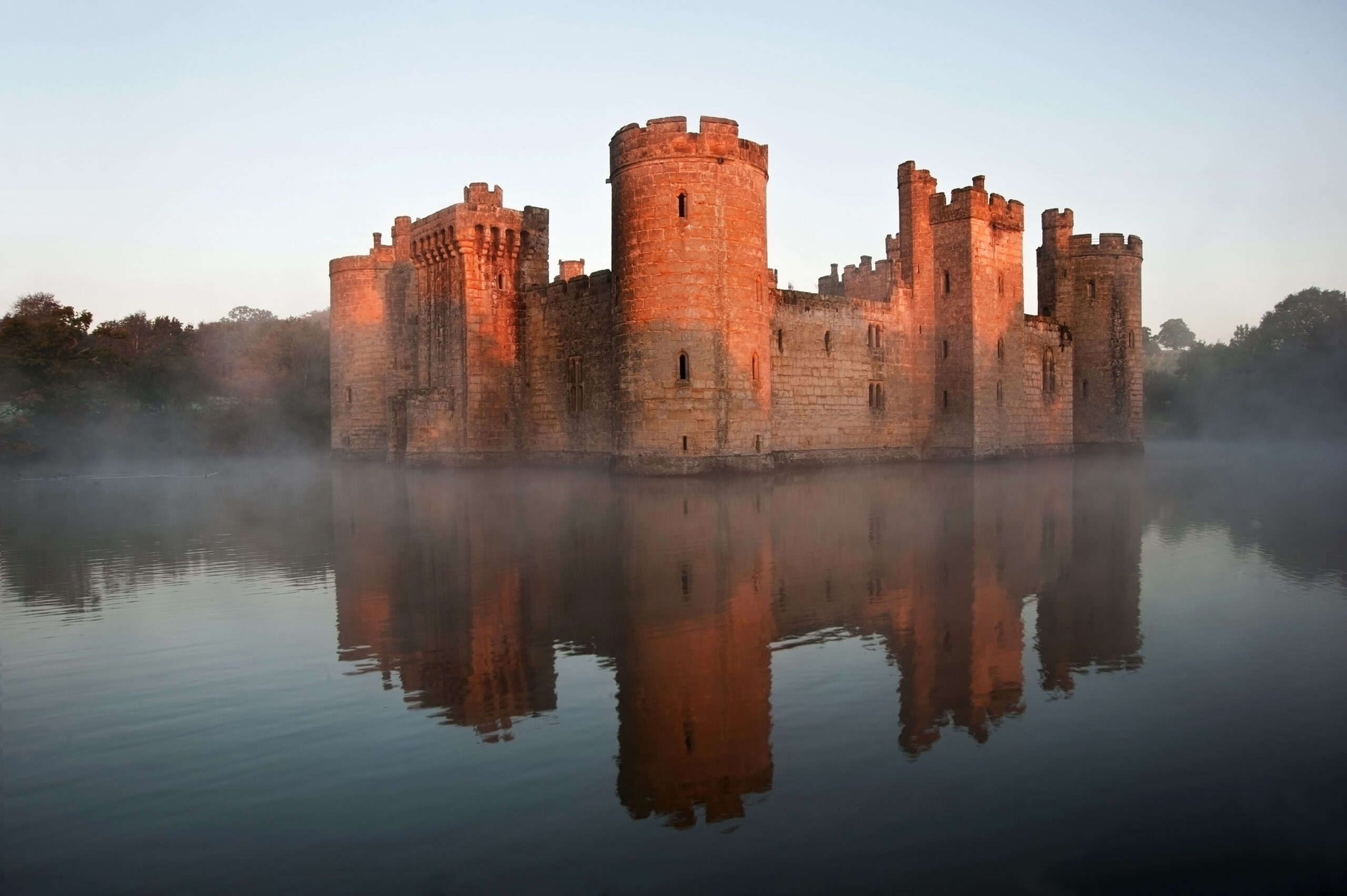Beautiful medieval castle and moat at sunrise