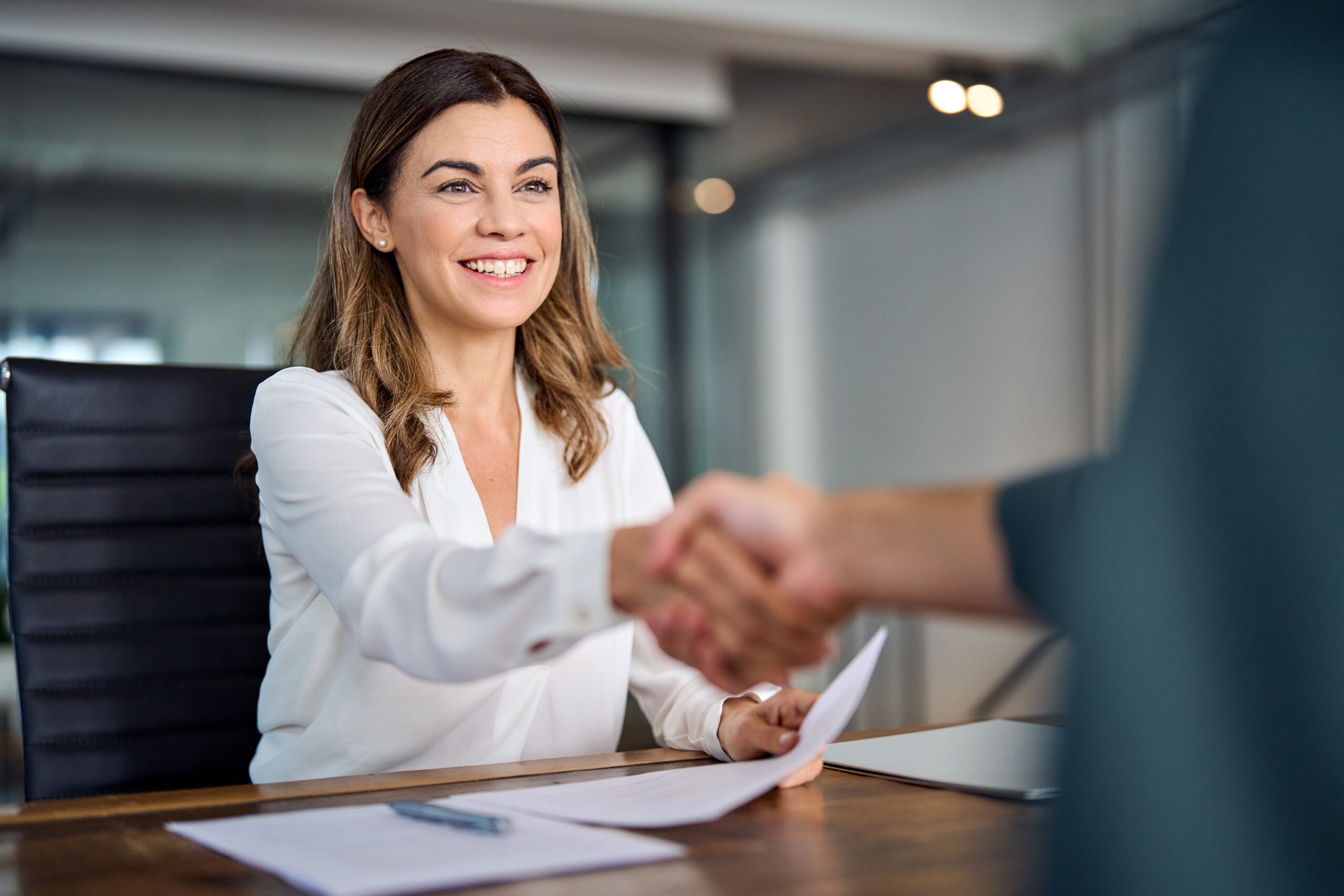 Happy mid aged business woman manager handshake