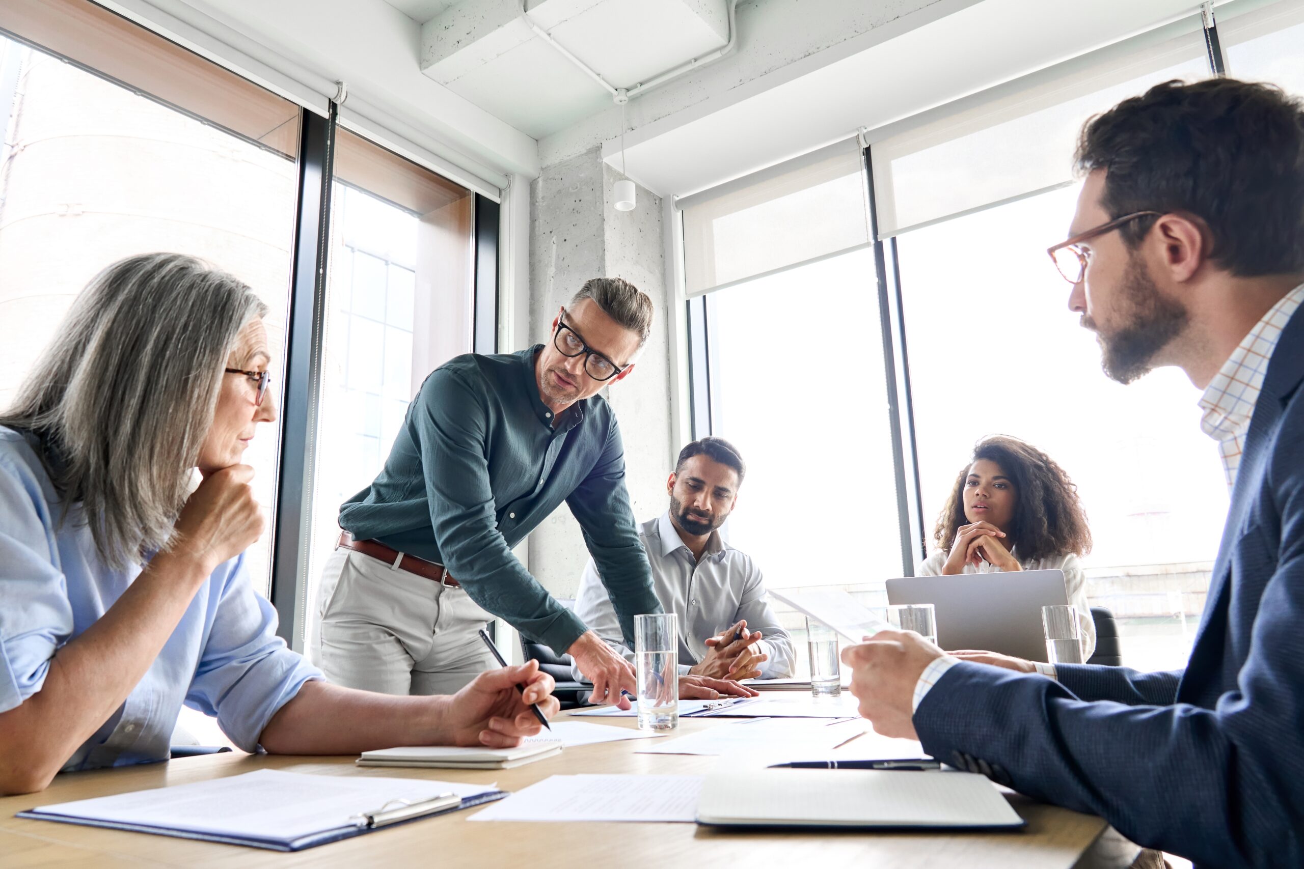 Male mature caucasian ceo businessman leader with diverse coworkers