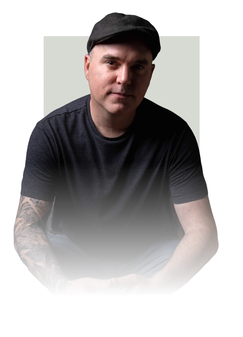 Rodney Warner, seated, in a flat cap and dark t-shirt